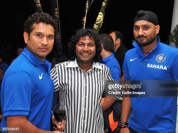 Sachin Tendulkar and Harbhajan Singh pose with a fan during the South African and Indian cricket team evening function at Summer Place on December...