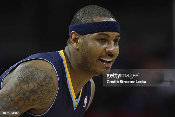 Carmelo Anthony of the Denver Nuggets watches on against the Charlotte Bobcats during their game at Time Warner Cable Arena on December 7, 2010 in...