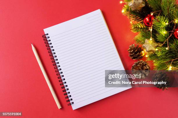 note pad and christmas ornaments - christmas list stock pictures, royalty-free photos & images