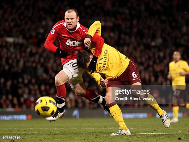 Wayne Rooney of Manchester United tangles with Laurent Koscielny of Arsenal during the Barclays Premier League match between Manchester United and...