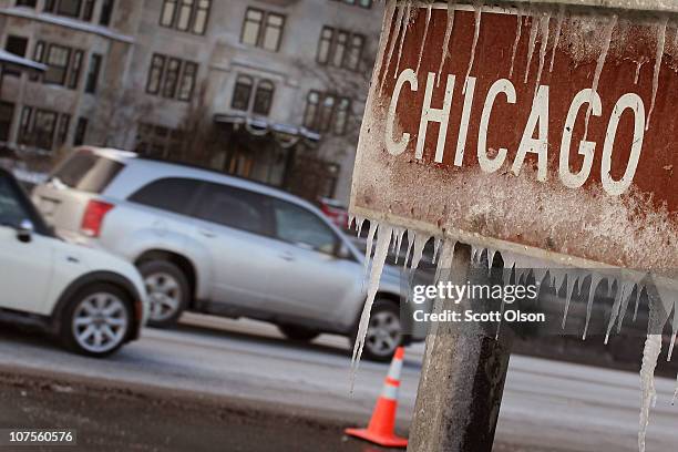 Ice clings to a sign along Lake Shore Drive after wind gusts upwards of 40 miles per hour blew waves onto the shore and temperatures in the low teens...