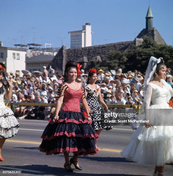 Dancers in traditional Mexican attire perform for spectators on Ocean Boulevard during the International Beauty Congress , Long Beach, California,...