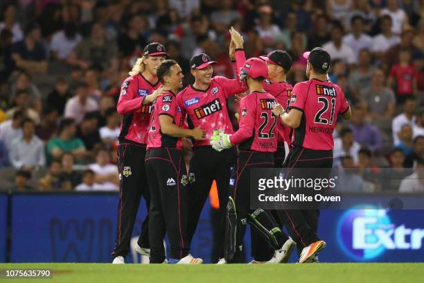 The Sydney Sixers celebrate after claiming the wicket of Mohammad Nabi of the Renegades during the Big Bash League match between the Melbourne...