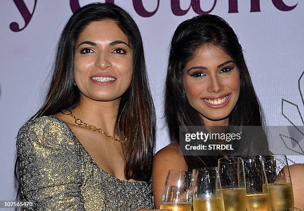 Winner of Miss India World 2008 Parvathy Omanakuttan poses with Indian model, beauty queen and winner of Miss Earth 2010 Nicole Faria during a press...