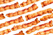 Background of bacon slices disposed in diagonal and isolated on white