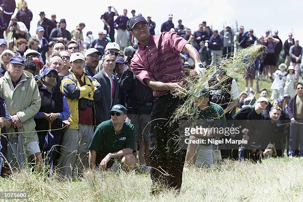 World No.1 Tiger Woods plays his second shot from the deep rough on the par 5 7th hole during the final round at the New Zealand Open 2002 at...