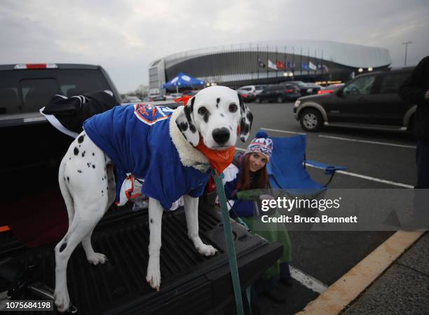 Fans bring along a dog with a New York Islanders jersey prior to the Islanders playing against the Columbus Blue Jackets on December 01, 2018 in...