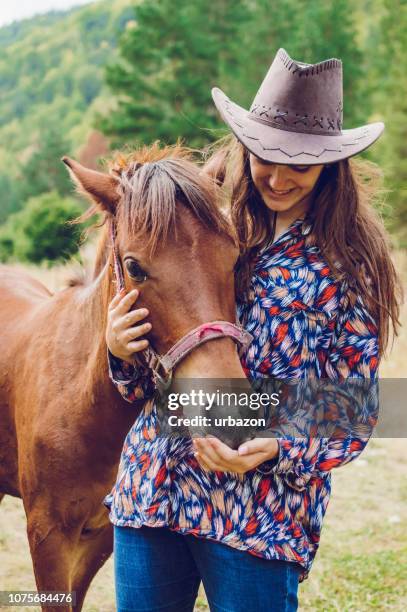 cowgirl with foal - rein stock pictures, royalty-free photos & images