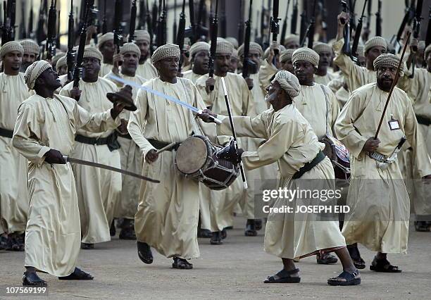 Omani tribesmen march during a parade at a stadium in Muscat marking 40 years since Omani ruler Sultan Qaboos bin Said took the throne on November...