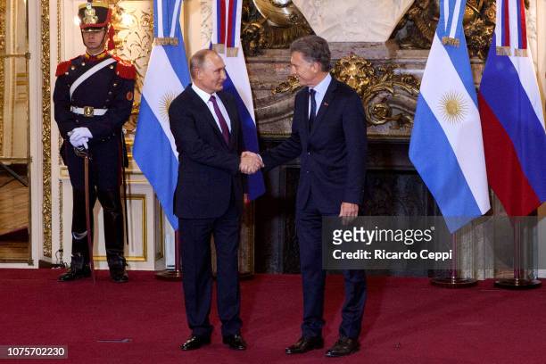Russian President Vladimir Putin shakes hands with President of Argentina Mauricio Macri prior to a meeting between the presidents of Argentina and...