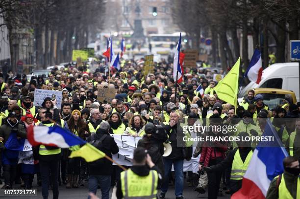 People march during a "yellow vest" anti-government demonstration in the northern city of Lille on December 29, 2018. - Police fired tear gas at...