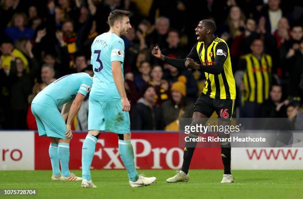 Abdoulaye Doucoure of Watford celebrates after scoring his team's first goal as Paul Dummett of Newcastle United reacts during the Premier League...