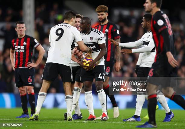 Aboubakar Kamara of Fulham argues with Aleksandar Mitrovic of Fulham over who will take the penalty ahead of Aboubakar Kamara of Fulham taking the...