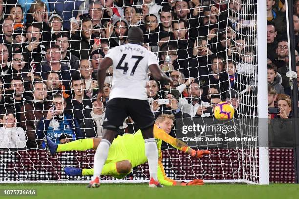Jonas Lossl of Huddersfield Town saves the penalty taken by Aboubakar Kamara of Fulham during the Premier League match between Fulham FC and...