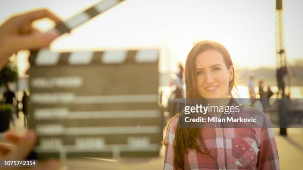 man hands holding movie clapper - film crew outside stock pictures, royalty-free photos & images