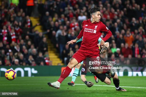 Roberto Firmino of Liverpool scores his sides first goal during the Premier League match between Liverpool FC and Arsenal FC at Anfield on December...