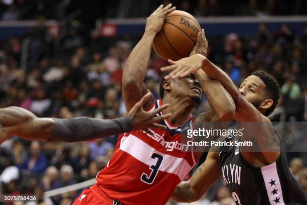 Bradley Beal of the Washington Wizards is fouled by Allen Crabbe of the Brooklyn Nets during the first half at Capital One Arena on December 01, 2018...