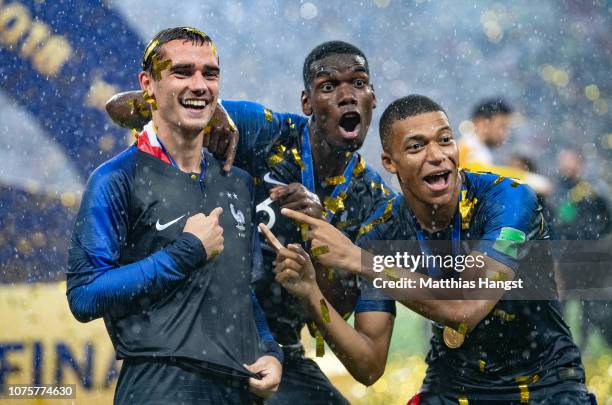 Antoine Griezmann, Paul Pogba, and Kylian Mbappe of France celebrate following their sides victory in the 2018 FIFA World Cup Final between France...