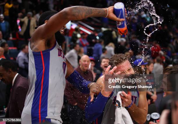 Blake Griffin of the Detroit Pistons is showered with water by Andre Drummond after a 11-102 win over the Golden State Warriors at Little Caesars...