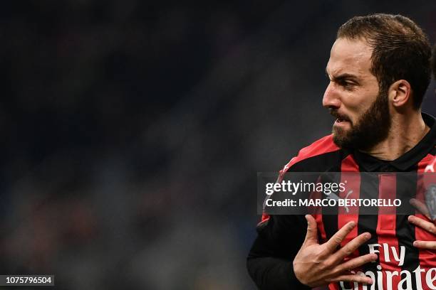 Milan's Argentine forward Gonzalo Higuain celebrates after scoring 2-1 during the Italian Serie A football match AC Milan vs Spal on December 29,...