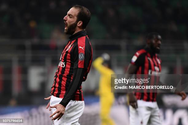 Milan's Argentine forward Gonzalo Higuain celebrates after scoring 2-1 during the Italian Serie A football match AC Milan vs Spal on December 29,...