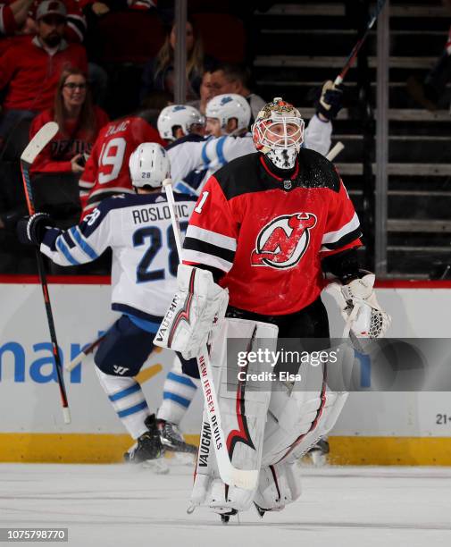 Keith Kinkaid of the New Jersey Devils skates off after Mark Scheifele of the Winnipeg Jets scored the game winner in overtime at Prudential Center...