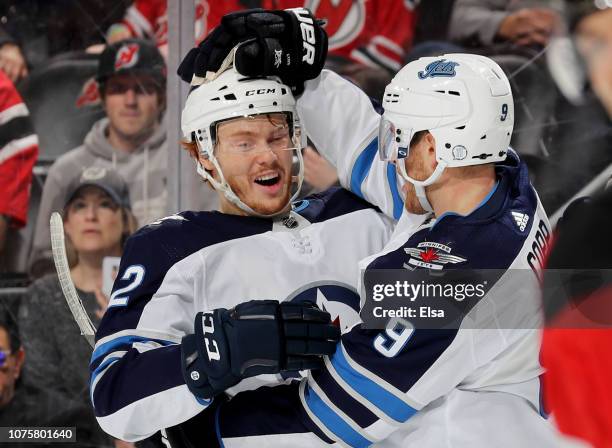 Mason Appleton of the Winnipeg Jets celebrates his assist with teammate and goal scoreer Andrew Copp in the third period against the New Jersey...