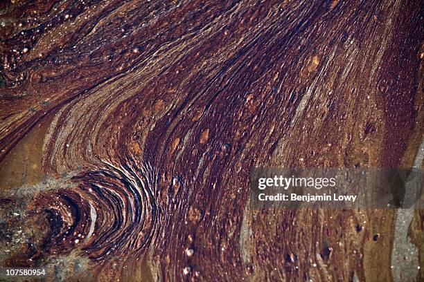 Crude oil released following the sinking of the BP Deepwater Horizon drilling rig, washes ashore on June 9, 2010 on Grand Terre Island, Louisiana.