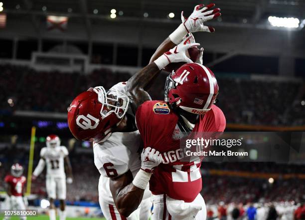Henry Ruggs III of the Alabama Crimson Tide completes the pass for a touchdown in the defense of Tre Brown of the Oklahoma Sooners during the College...