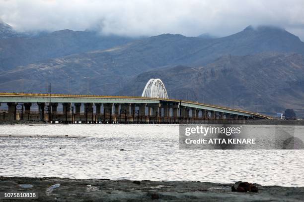 This picture taken on December 8, 2018 shows a view of the Shahid Kalantari causeway which crosses the salt lake of Urmia in the northwest of Iran,...