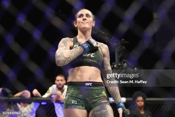 Megan Anderson of Australia reacts after defeating Cat Zingano by TKO in the first round of a Women's Featherweight bout during the UFC 232 event...