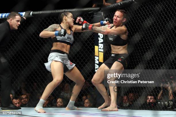 Amanda Nunes of Brazil punches Cris Cyborg of Brazil in their women's featherweight bout during the UFC 232 event inside The Forum on December 29,...