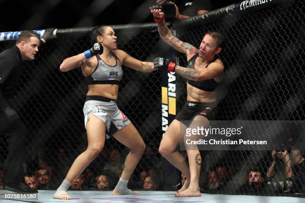Amanda Nunes of Brazil punches Cris Cyborg of Brazil in their women's featherweight bout during the UFC 232 event inside The Forum on December 29,...