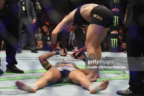 Cris Cyborg of Brazil congratulates Amanda Nunes of Brazil after Cris Cyborg of Brazil was knocked out in their women's featherweight bout during the...