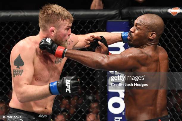 Alexander Gustafsson of Sweden punches Jon Jones in their light heavyweight bout during the UFC 232 event inside The Forum on December 29, 2018 in...