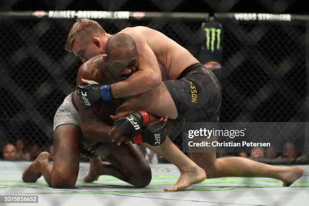 Alexander Gustafsson of Sweden controls the body of Jon Jones in their light heavyweight bout during the UFC 232 event inside The Forum on December...