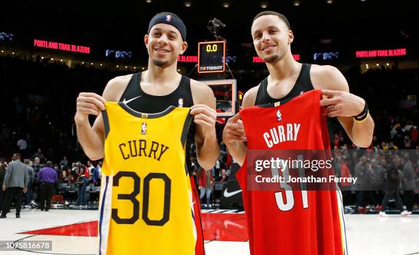 Stephen Curry of the Golden State Warriors trades jerseys after the game with his brother Seth Curry of the Portland Trail Blazers at Moda Center on...