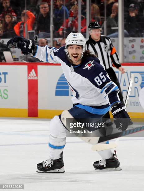 Mathieu Perreault of the Winnipeg Jets celebrates teammate Josh Morrissey's goal in the third period against the New Jersey Devils at Prudential...