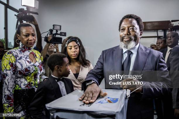 President of the Democratic Republic of Congo Joseph Kabila casts his vote along with his family at the Insititut de la Gombe polling station during...