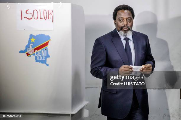 President of the Democratic Republic of Congo Joseph Kabila proceeds to cast his vote at the Insititut de la Gombe polling station during general...