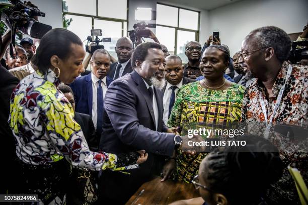 President of the Democratic Republic of Congo Joseph Kabila greets some electoral observers after casting his vote at the Insititut de la Gombe...