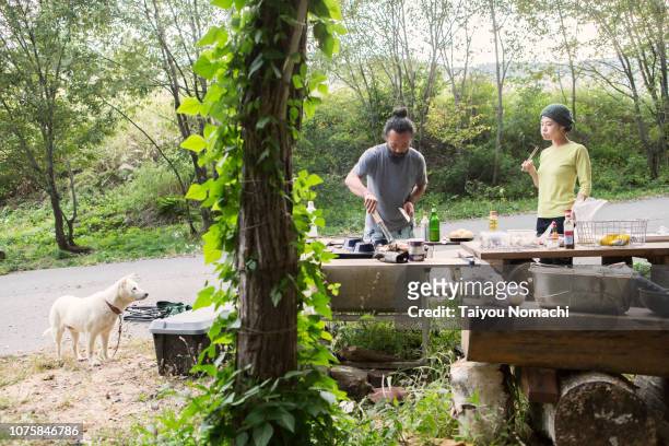 Couples and dogs enjoying barbecue
