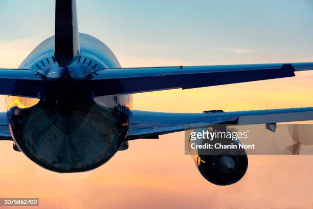 low angle view of airplane flying against sky during sunset - ガトウィック空港 ストックフォトと画像