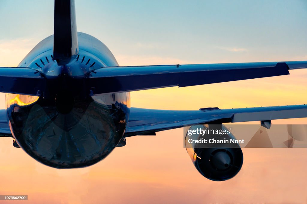 Low Angle View Of Airplane Flying Against Sky During Sunset
