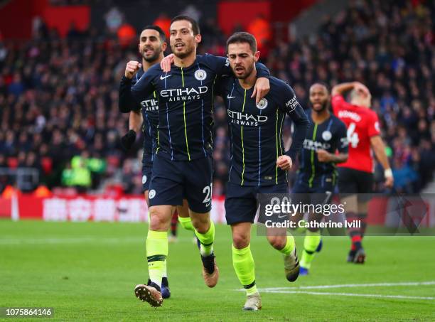 David Silva of Manchester City celebrates after scoring his team's first goal with team mates Bernardo Silva and Riyad Mahrez of Manchester City...