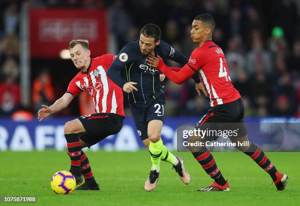 David Silva of Manchester City battles with James Ward-Prowse of Southampton and Yan Valery of Southampton during the Premier League match between...