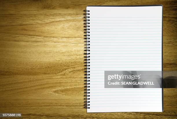 blank notebook on desk - spiraalblok stockfoto's en -beelden