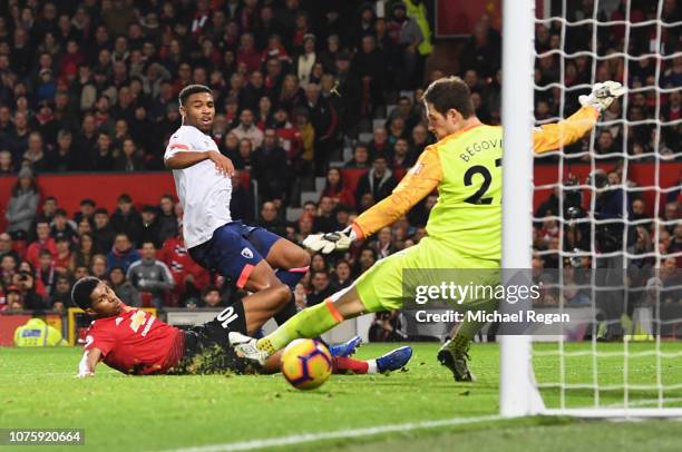 Marcus Rashford of Manchester United beats Jordon Ibe and Asmir Begovic of AFC Bournemouth as he scores his team's third goal during the Premier...