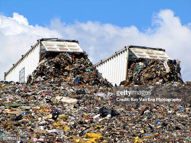 two dump trucks at landfill - landfill stock-fotos und bilder