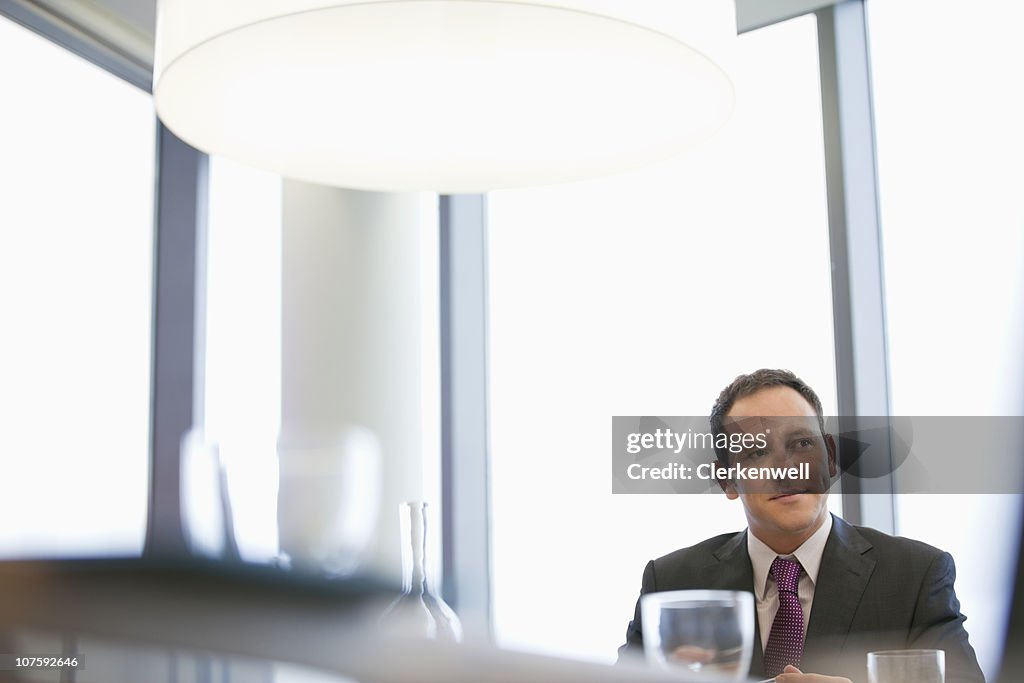 Contemplative businessman sitting at conference table